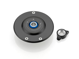 A black Rizoma billet aluminum gas cap for BMW with a blue key lock system.